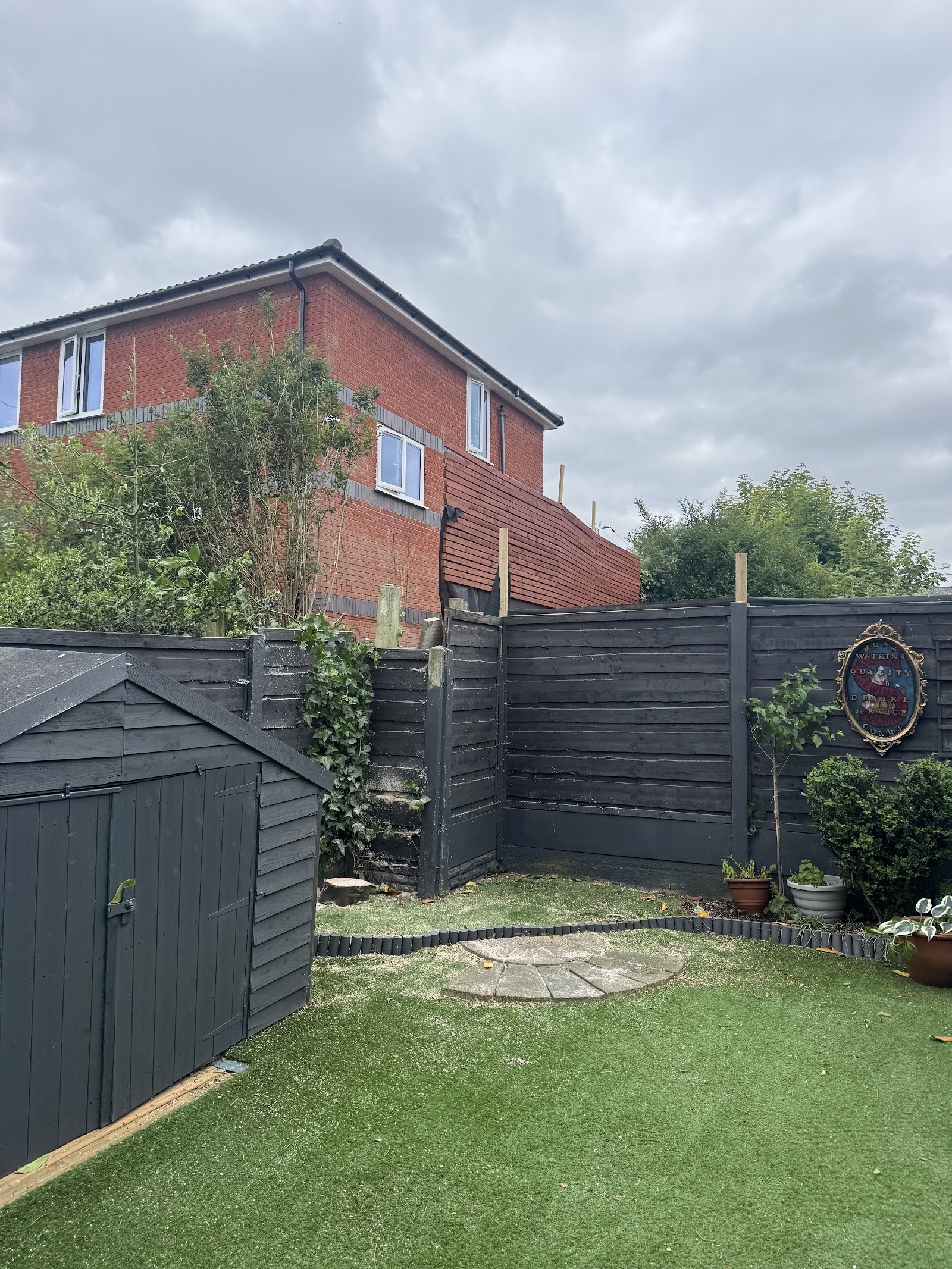 A neat Chadderton back garden with swept patio and clean fence line after tree work